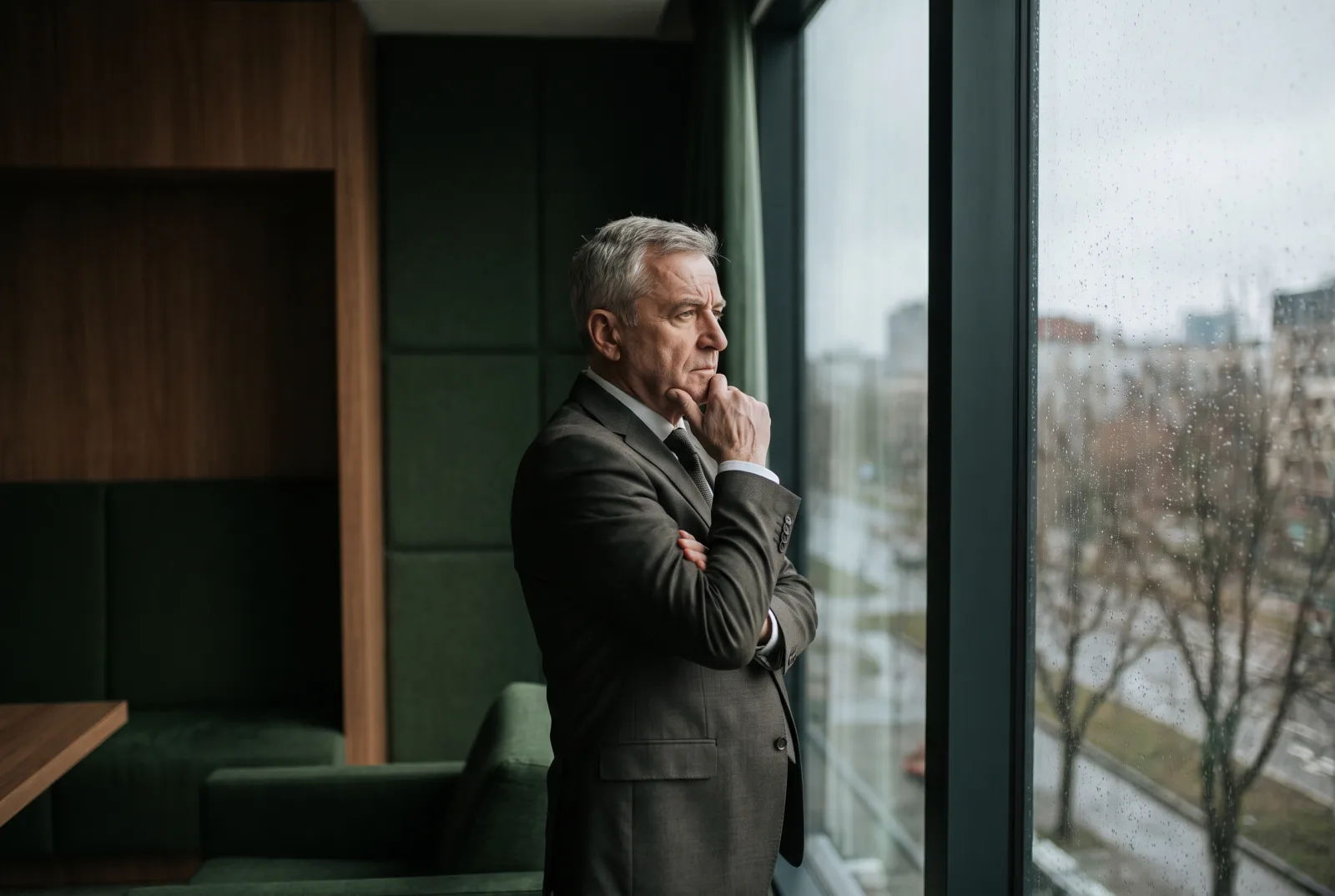 A seasoned business owner in his office, in a reflective moment about the security of what he built