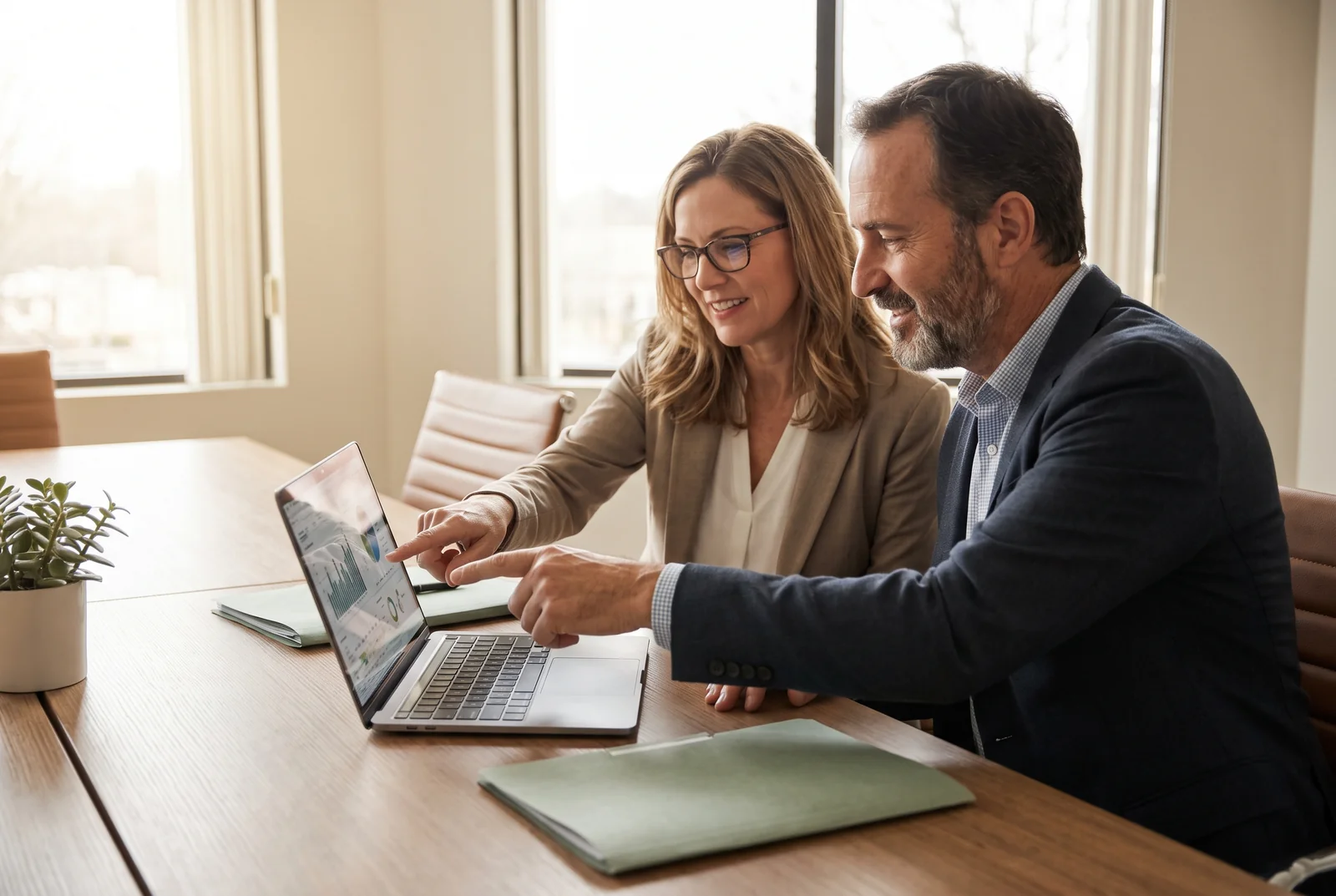 A Zamak advisor and an insurance agency manager reviewing an executive security and continuity report together